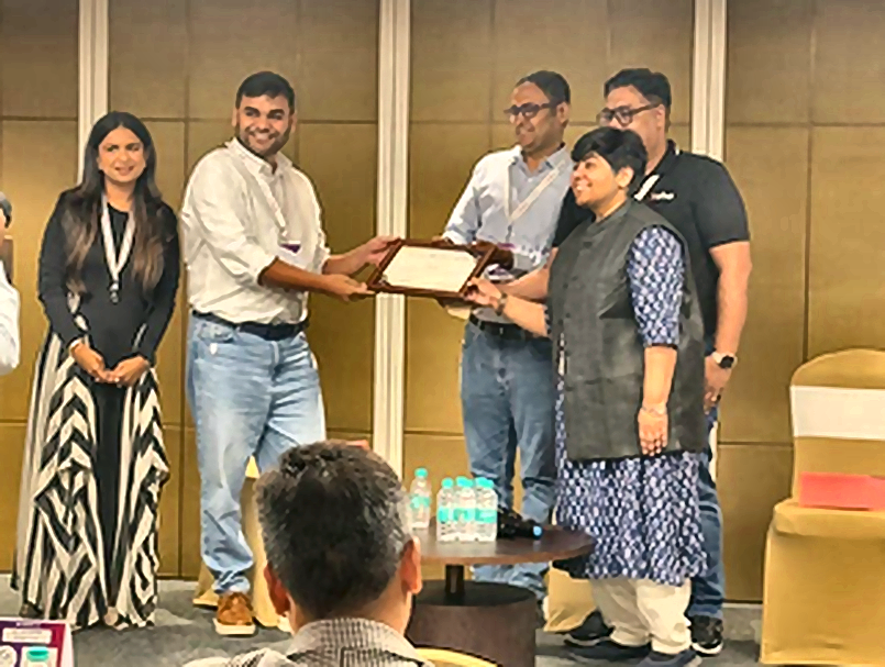 GISUL team receiving a recognition plaque on stage